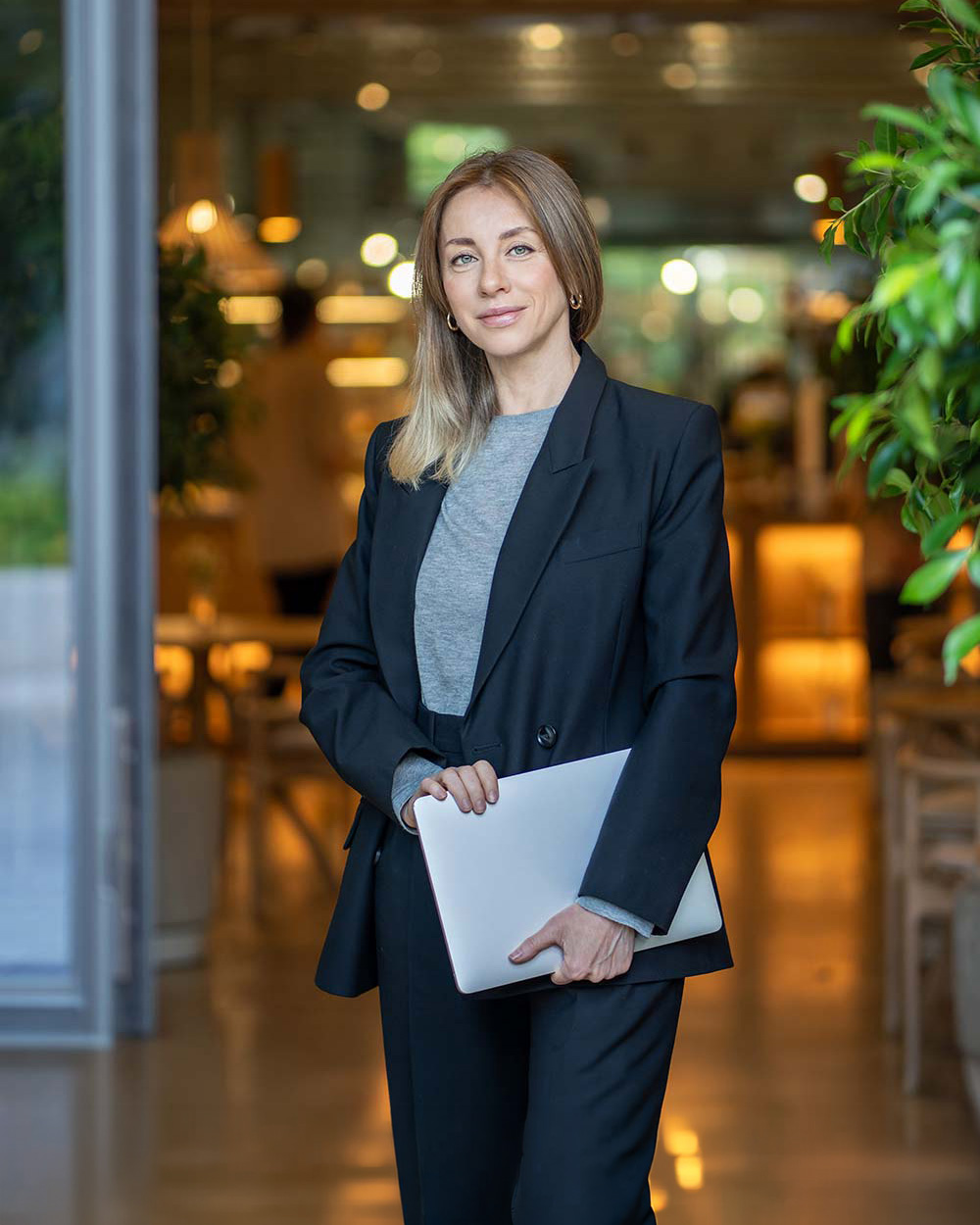 Confident businesswoman holding a laptop, representing flexible working capital funding options from Bizcap.